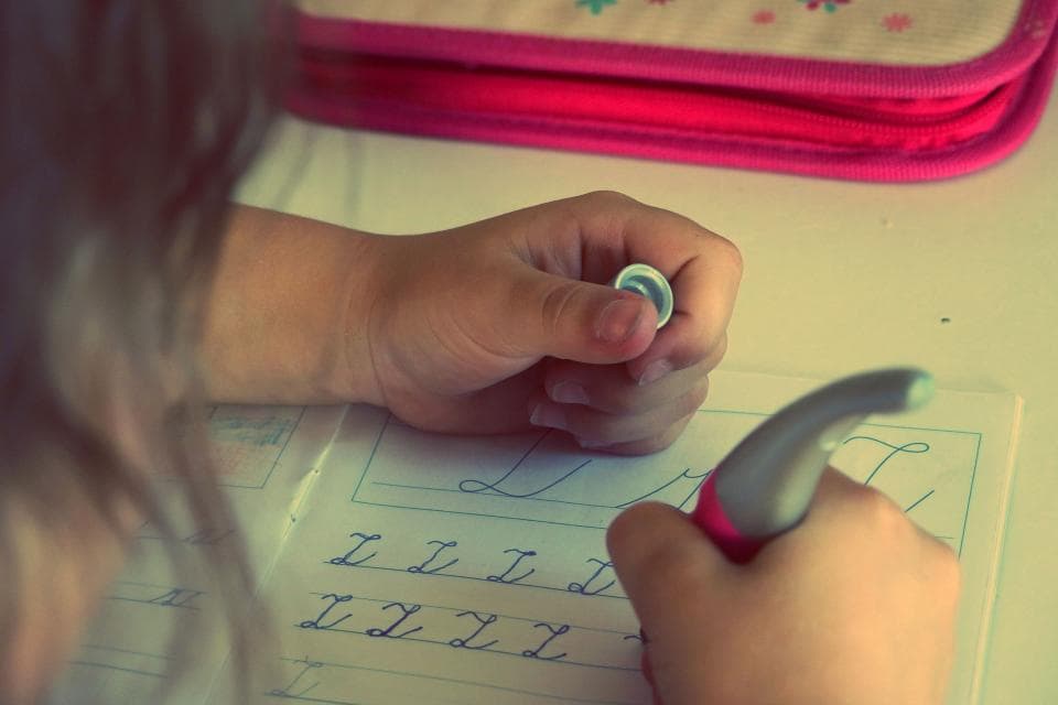 Student practicing handwriting during an in-person tutoring session